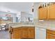Kitchen with tile countertops, white appliances, wood cabinets, and adjacent dining area at 1199 Golf Club, Laughlin, NV 89029