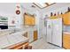 Bright kitchen featuring white appliances, tile countertops, and ample wood cabinets at 1199 Golf Club, Laughlin, NV 89029