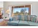 Bright living room with a view of the lush greenery and golf course beyond the window at 1199 Golf Club, Laughlin, NV 89029