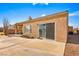 View of the back of the home with a patio, sliding glass door, and desert landscaping at 1199 Golf Club, Laughlin, NV 89029