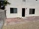Back patio of home showing paver stones with a small white dog at 1249 Lucia Dr, Las Vegas, NV 89128