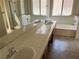 Well-lit bathroom with double sinks, separate bathtub, shower, and tile floors at 1249 Lucia Dr, Las Vegas, NV 89128