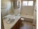 A full bathroom with a tub, a window, tile countertops and a wooden cabinet at 1249 Lucia Dr, Las Vegas, NV 89128