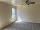Cozy bedroom featuring carpeted floors, a ceiling fan, and a window for natural light at 1249 Lucia Dr, Las Vegas, NV 89128