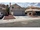Charming single-story home with a two-car garage, front rock landscaping, and tile roof at 1249 Lucia Dr, Las Vegas, NV 89128