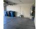 A spacious garage with trash bins, water heater, and ample storage space at 1249 Lucia Dr, Las Vegas, NV 89128