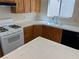 Bright kitchen with white tile countertops, stainless steel appliances and wood cabinets at 1249 Lucia Dr, Las Vegas, NV 89128