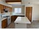 Bright eat-in kitchen with white tile countertops, stainless steel appliances, and tile floors at 1249 Lucia Dr, Las Vegas, NV 89128