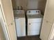 Enclosed laundry area featuring white washer and dryer with louvered bi-fold doors at 1249 Lucia Dr, Las Vegas, NV 89128