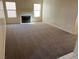 Spacious living room featuring a white fireplace, carpeted floors, and abundant natural light at 1249 Lucia Dr, Las Vegas, NV 89128