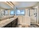 Modern bathroom featuring walk-in tub, walk-in shower, granite counters, and updated fixtures at 127 Mauve St, Henderson, NV 89012