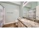 Clean bathroom with granite countertops, modern sink, updated lighting, and shower with curtain at 127 Mauve St, Henderson, NV 89012