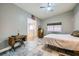 Bedroom with vaulted ceiling, neutral colors, vintage sewing machine, and en-suite bathroom at 127 Mauve St, Henderson, NV 89012