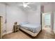 Simple bedroom with neutral walls and flooring, ceiling fan, and adjacent closet space at 127 Mauve St, Henderson, NV 89012