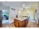 Open-concept kitchen with granite counters, island, wood floors, and easy access to living and dining areas at 127 Mauve St, Henderson, NV 89012