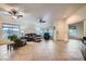 Open living room with tile flooring, neutral color palette, multiple windows, and ceiling fans at 127 Mauve St, Henderson, NV 89012