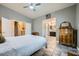 Spacious bedroom with en-suite bathroom, vintage dresser, and access to other living areas at 127 Mauve St, Henderson, NV 89012
