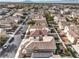 Aerial view showing street lined with parked cars and lush lawns at 1324 Spice Ridge Ct, Henderson, NV 89012