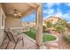Inviting back patio with ceiling fan, outdoor kitchen, pond and luscious green lawn at 1324 Spice Ridge Ct, Henderson, NV 89012