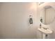 Half bathroom featuring pedestal sink and round mirror at 1324 Spice Ridge Ct, Henderson, NV 89012