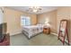 Comfortable bedroom with carpet flooring, ceiling fan, and natural light from a window at 1324 Spice Ridge Ct, Henderson, NV 89012