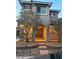 Two-story home featuring a covered porch with an arched entrance, set against a rock-covered landscape at 1324 Spice Ridge Ct, Henderson, NV 89012