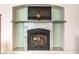Inviting fireplace with glass doors, tiled surround, and mounted television in an elegant setting at 1324 Spice Ridge Ct, Henderson, NV 89012