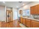 Functional kitchen with stainless steel refrigerator, dishwasher, and ample cabinet space at 1324 Spice Ridge Ct, Henderson, NV 89012