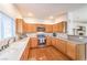 Well-lit kitchen with wood cabinets, stainless steel appliances, and hardwood floors at 1324 Spice Ridge Ct, Henderson, NV 89012