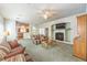 A bright living space featuring a fireplace, cozy seating, and a glimpse of the kitchen and dining area at 1324 Spice Ridge Ct, Henderson, NV 89012