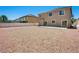 Large gravel backyard of a two-story home with space to customize landscaping at 16 Goldleaf Falls Ave, North Las Vegas, NV 89031