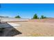 Large backyard offers potential for landscaping, featuring concrete patio and privacy wall at 16 Goldleaf Falls Ave, North Las Vegas, NV 89031