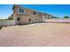Spacious backyard featuring a rock landscape, privacy fencing, and a concrete patio area at 16 Goldleaf Falls Ave, North Las Vegas, NV 89031