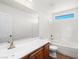 Bright bathroom showcases a shower-tub combo, wood vanity, and brushed gold fixtures at 16 Goldleaf Falls Ave, North Las Vegas, NV 89031