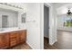Bathroom featuring wooden cabinets, dual sinks, and a large mirror at 16 Goldleaf Falls Ave, North Las Vegas, NV 89031