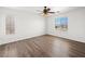 Bedroom with wood-look flooring, ceiling fan, and view of the mountains at 16 Goldleaf Falls Ave, North Las Vegas, NV 89031