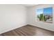 Bright bedroom featuring wood-look flooring and a large window with mountain views at 16 Goldleaf Falls Ave, North Las Vegas, NV 89031