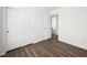 Bedroom features wood-look flooring, a double-door closet, and a white interior door at 16 Goldleaf Falls Ave, North Las Vegas, NV 89031