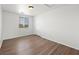 This bedroom offers wood-look flooring, a window with blinds, and a closet at 16 Goldleaf Falls Ave, North Las Vegas, NV 89031
