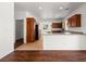 Open kitchen with wood cabinets, granite countertops, tile flooring, and modern appliances at 16 Goldleaf Falls Ave, North Las Vegas, NV 89031