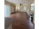Open-plan living room with wood floors and large windows at 16 Goldleaf Falls Ave, North Las Vegas, NV 89031