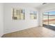 Bright living room boasts tile floors, two windows, and sliding glass door to backyard at 16 Goldleaf Falls Ave, North Las Vegas, NV 89031