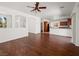 Bright and open living room with hardwood floors, white walls, and views of the kitchen at 16 Goldleaf Falls Ave, North Las Vegas, NV 89031