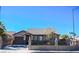 Charming single-story home featuring desert landscaping and a decorative wrought iron fence at 1713 Golden Sky Dr, Las Vegas, NV 89106