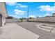 Spacious backyard featuring a concrete patio, rock landscaping, and perimeter fencing at 1800 Atlantic St, Las Vegas, NV 89104