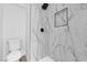 A bathroom featuring marble-look shower tile, niche, and sleek fixtures at 1800 Atlantic St, Las Vegas, NV 89104