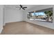 Sunlit room featuring neutral walls, ceiling fan, and large windows with neighborhood views at 1800 Atlantic St, Las Vegas, NV 89104