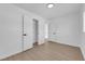 Minimalist room with walk-in closet, bright neutral walls, and wood-look floors at 1800 Atlantic St, Las Vegas, NV 89104