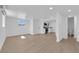 Bright, open-concept living area with wood-look floors, opening to the kitchen and bathroom at 1800 Atlantic St, Las Vegas, NV 89104