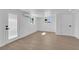 Bright room with wood-look floors, white walls, and a door to the outside at 1800 Atlantic St, Las Vegas, NV 89104